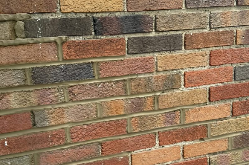 Close-up of fresh mortar application during a brick repointing and tuckpointing project