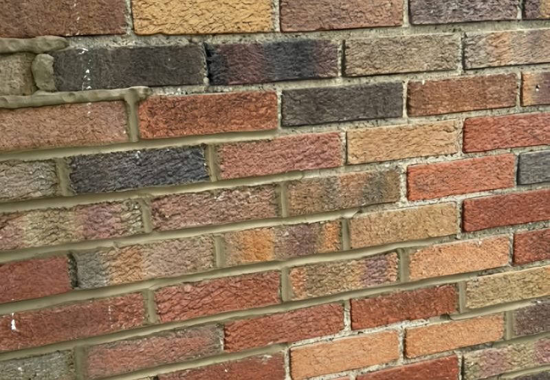 Close-up of fresh mortar application during a brick repointing and tuckpointing project